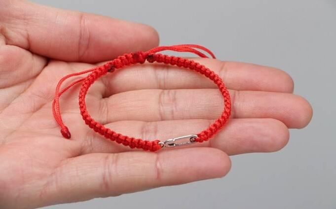 Red thread that protects against evil (on the left wrist) and attracts happiness (on the right wrist)